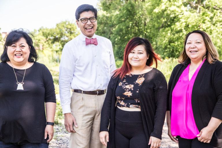 Four staff members of Coalition of Asian American Leaders standing at Frogtown Farms.