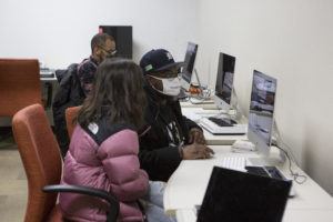 Teenage youth learn about digital music production.