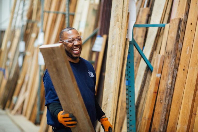 Man stacking wood at Better Futures warehouse