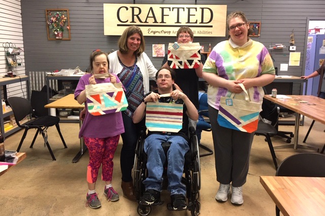 Group of Itasca Life Options clients holding art