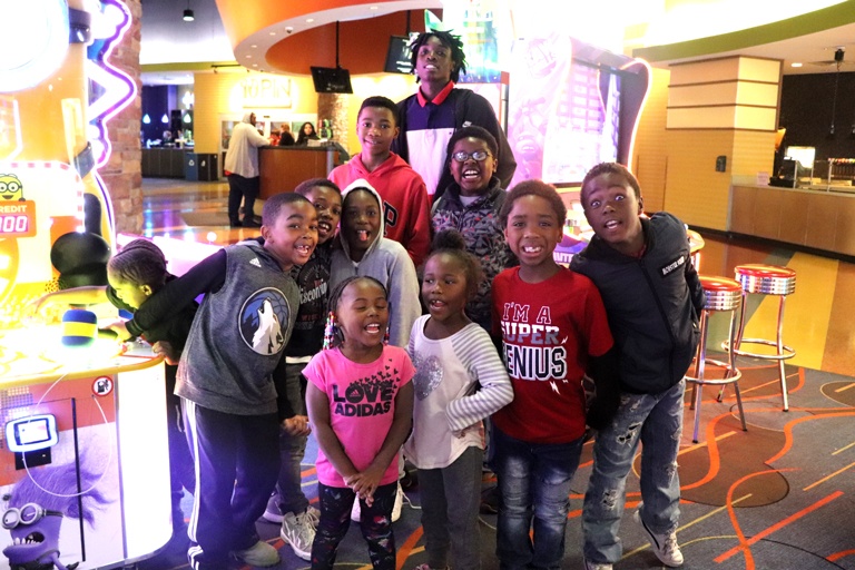 Group of kids posing together at arcade